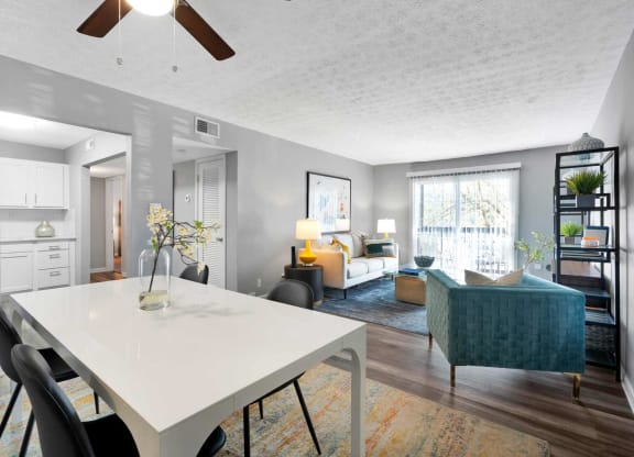 an open living room and dining room with a white table at Station JTown, Kentucky, 40299