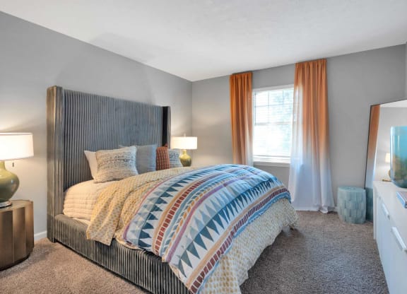 a bedroom with a bed and a window at Station JTown, Louisville, KY