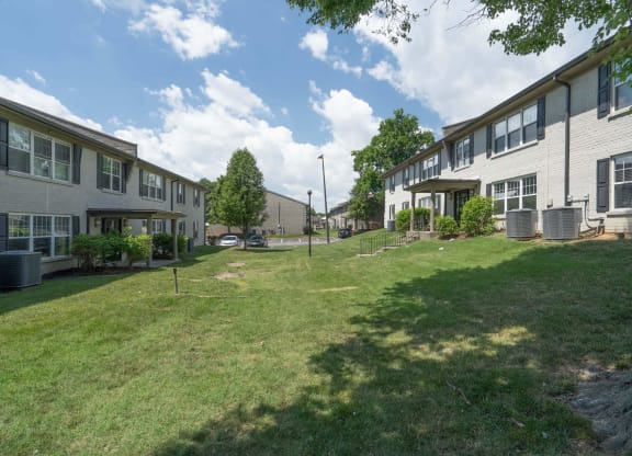 a grassy area with a tree in the middle of it at Enclave at Breckenridge Apartments, Louisville, KY