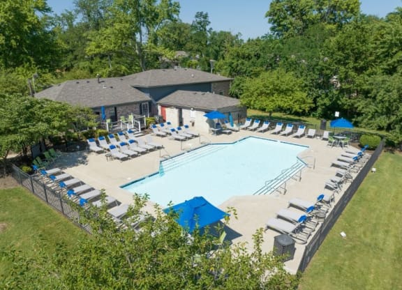 an aerial view of a resort style pool with lounge chairs and umbrellas at Station JTown, Louisville, KY
