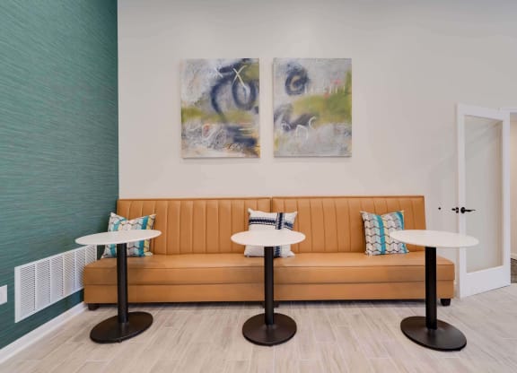 a seating area with a couch and two tables at Station JTown, Louisville, KY 40299