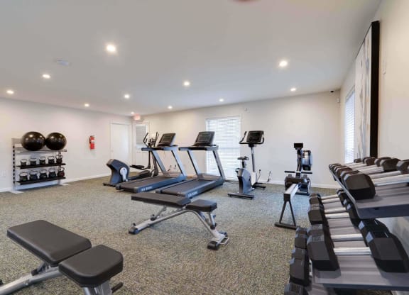 a gym with treadmills and other exercise equipment at Station JTown, Louisville, KY