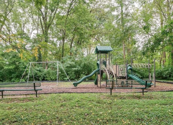 a playground with a swing set and a jungle gym at Station JTown, Louisville, 40299