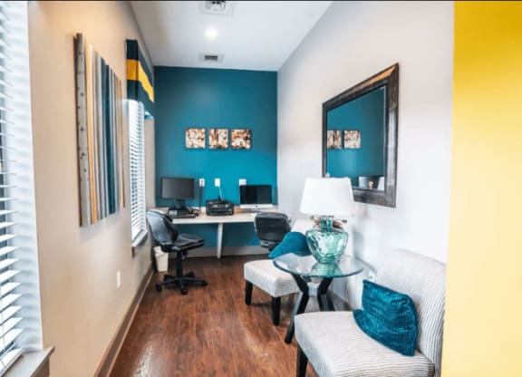 a room with a desk and two chairs and a large mirror at Enclave at Breckenridge Apartments, Louisville, KY