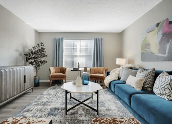 a living room with a blue couch at Enclave at Breckenridge Apartments, Louisville, 40220