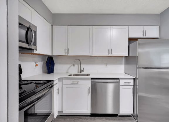 a kitchen with white cabinets and stainless steel appliances at Enclave at Breckenridge Apartments, Louisville, KY, 40220