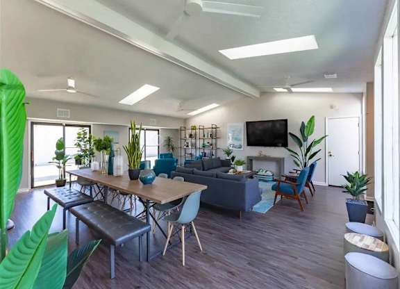 A modern living room with a long table and chairs.