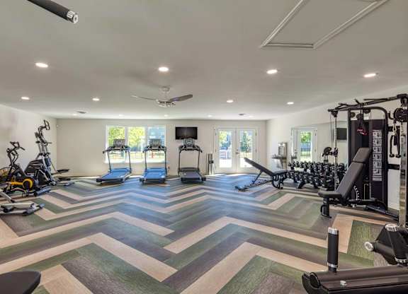 A spacious gym with a variety of exercise equipment.