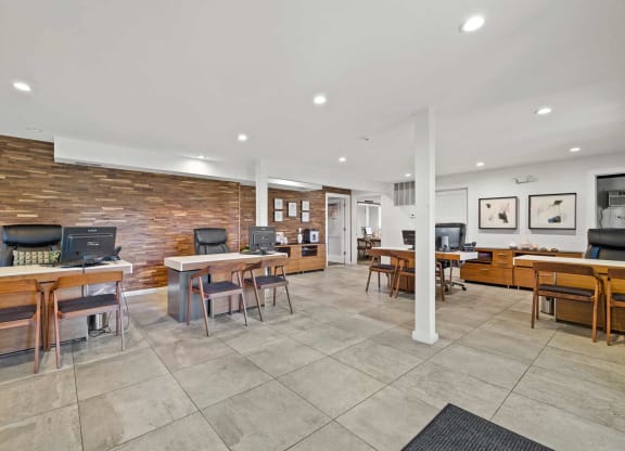 a living room with tables and chairs and a tv