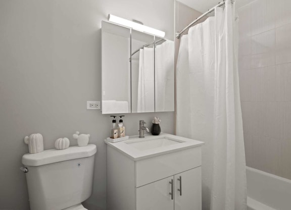 a bathroom with a sink toilet and a shower