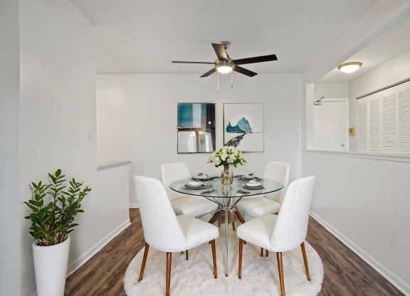 a dining room with a glass table and chairs