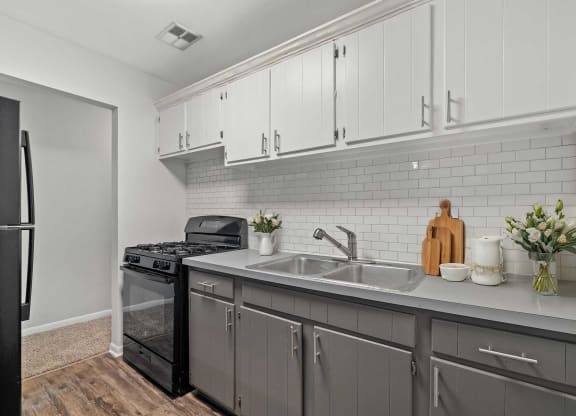 a kitchen with a sink and a refrigerator
