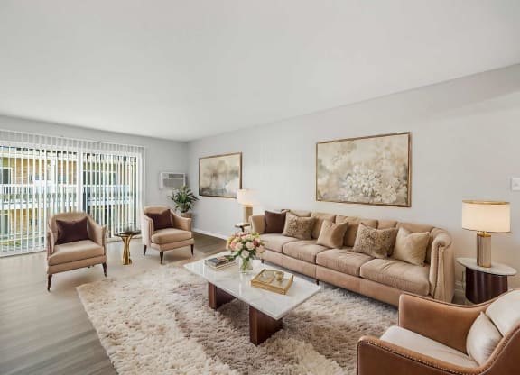 a living room with a couch and chairs and a coffee table