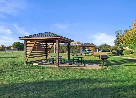 a picnic table with a pavilion in a park