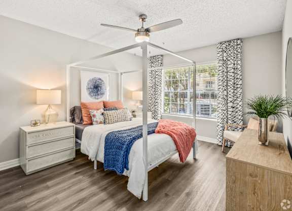 A bedroom with a bed, dresser, and mirror.at Coastline Apartments, Florida, 32547 