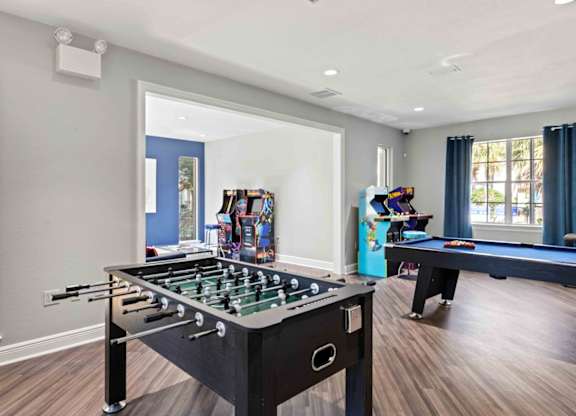 A pool table in a room with a foosball table and a pool table.at Coastline Apartments, Fort Walton Beach, 32547  