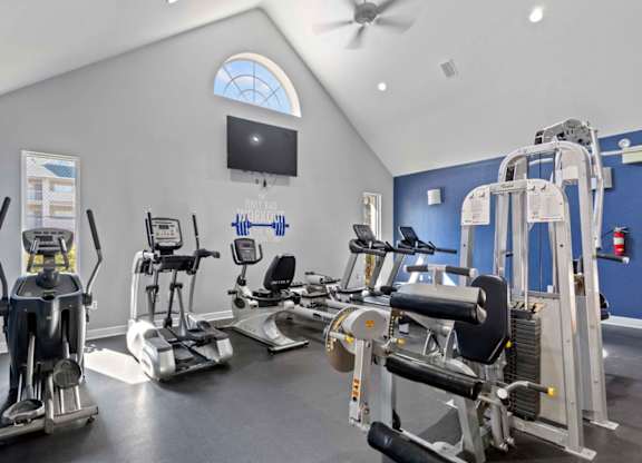 A gym with a variety of exercise equipment including treadmills, stationary bikes, and weight machines.at Coastline Apartments, Fort Walton Beach, FL 32547  