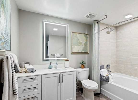 a bathroom with a tub sink toilet and a mirror at Mayla Pompano, Pompano Beach, 33062