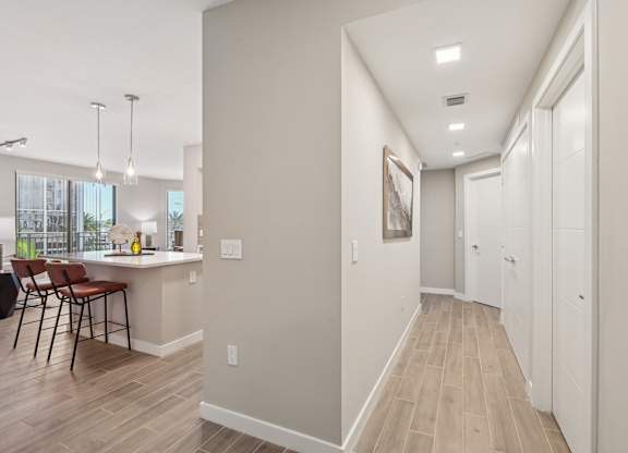 A long hallway with a white door at the end.