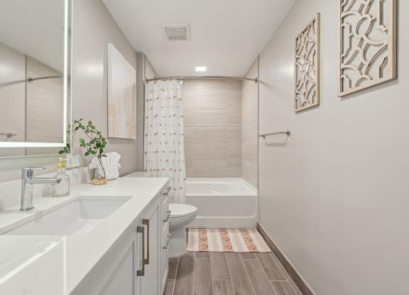 A bathroom with a white sink and a white toilet.