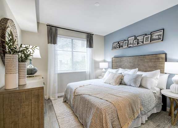 A bedroom with a large bed and a wooden headboard at Mayla Pompano, Pompano Beach, Florida