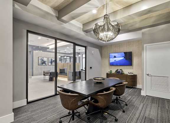 A conference room with a large table and chairs at Mayla Pompano, Pompano Beach, FL