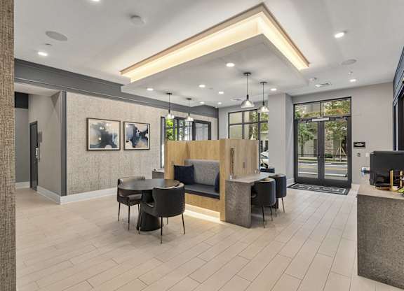 A modern office lobby with a reception desk and seating area at Mayla Pompano, Pompano Beach, 33062