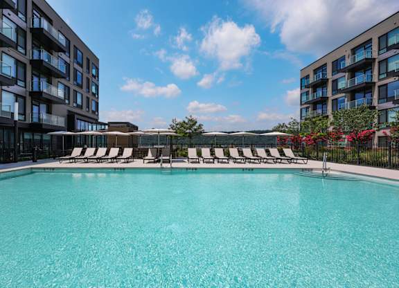 Swimming pool surrounded by lounge chairs at Hudson Piers, Yonkers, 10701