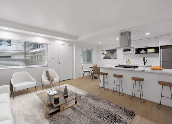 A modern kitchen with white cabinets and a bar area.