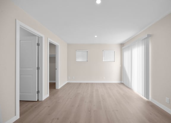A room with wooden floors and white walls.