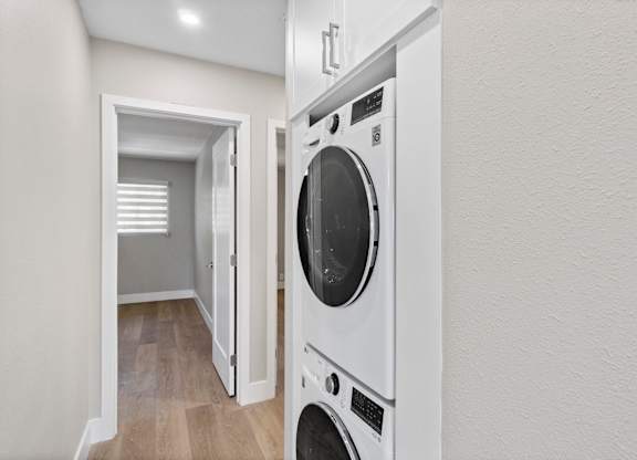 A white washing machine is in a small room.