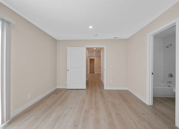 A room with wooden floors and white walls.
