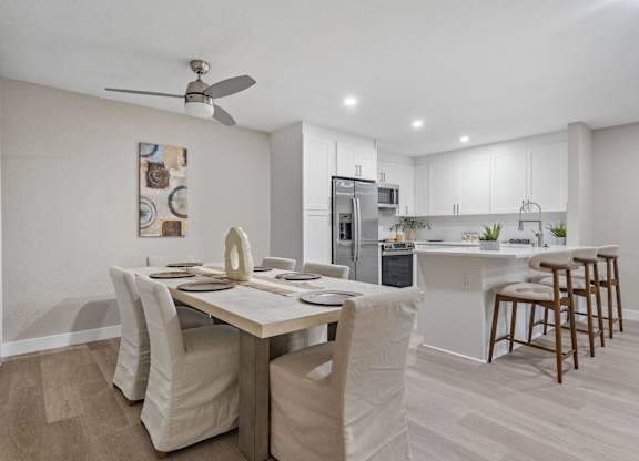 A modern kitchen with a dining table and chairs at Tamarack Sands Apartment Homes, Carlsbad, CA
