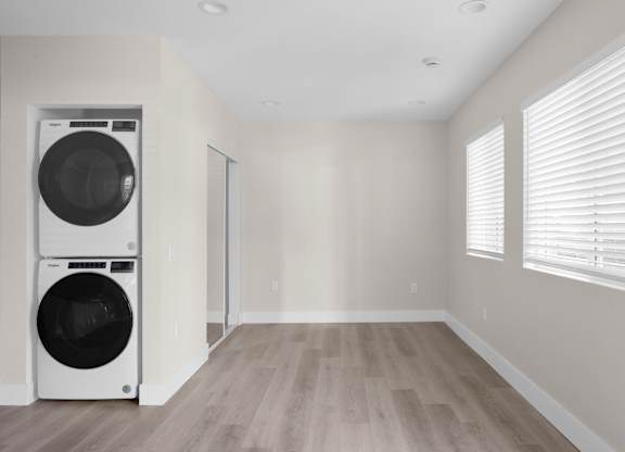 A laundry room with a washer and dryer stacked on top of each other.