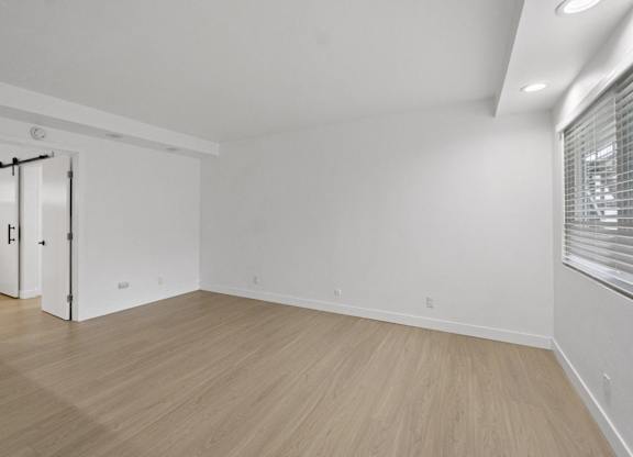 A room with a sliding door and wooden flooring. at Torrance Gateway Apartments, Torrance, 90501