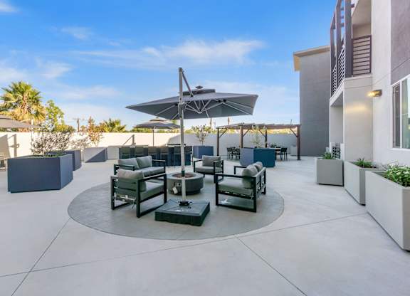 A patio with a table and chairs under an umbrella.at The Reserve La Mirada, La Mirada, 90638