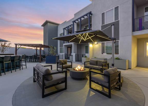 A patio with a fire pit and seating area.at The Reserve La Mirada, California