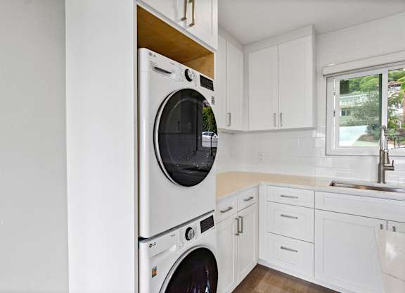 A white washing machine in a kitchen.