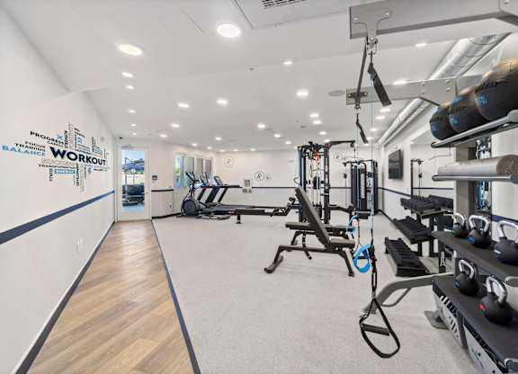 A gym with a variety of equipment including weights and machines.at The Reserve La Mirada, California, 90638