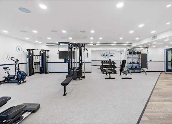 A gym with a variety of equipment including treadmills, weights, and exercise machines.at The Reserve La Mirada, La Mirada, California