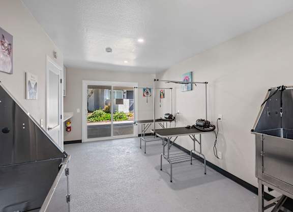 A kitchen area with a table and chairs.