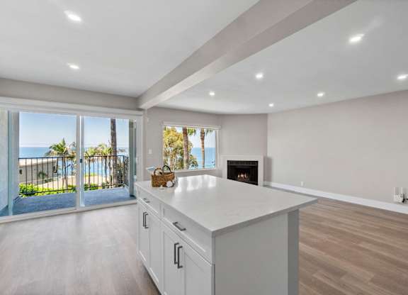 A modern kitchen with a view of the beach.
