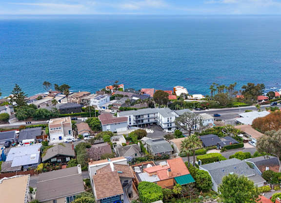 A coastal residential area with houses and trees.