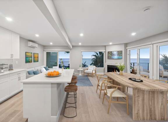 A modern kitchen with a dining table and chairs.at Ocean Edge @ Laguna Beach, Laguna Beach, CA