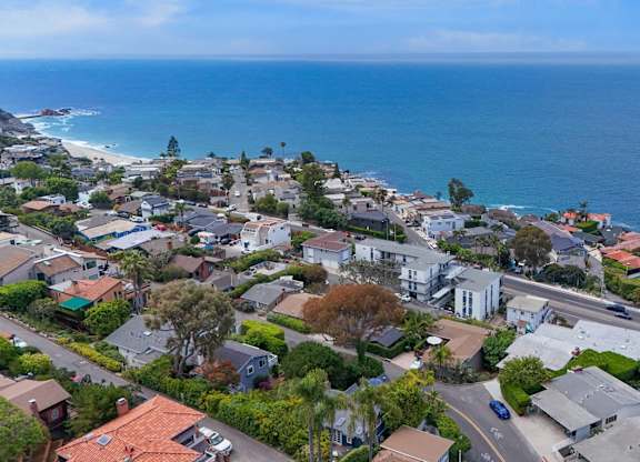A coastal residential area with houses and a road.