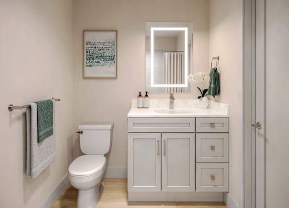 A white toilet sits next to a white sink in a small bathroom.