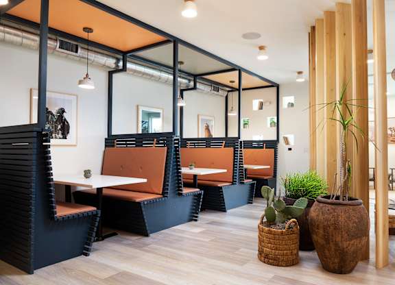 A modern cafe with wooden tables and chairs. at The Reserve La Mirada, La Mirada, California