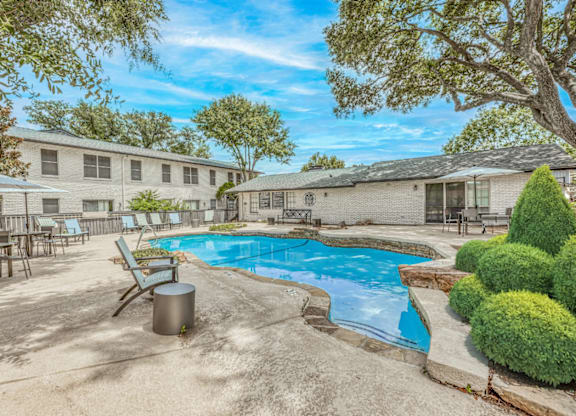 Resort style swimming pool with patio seating at Northwood Heights Apartments, Dallas, 75248