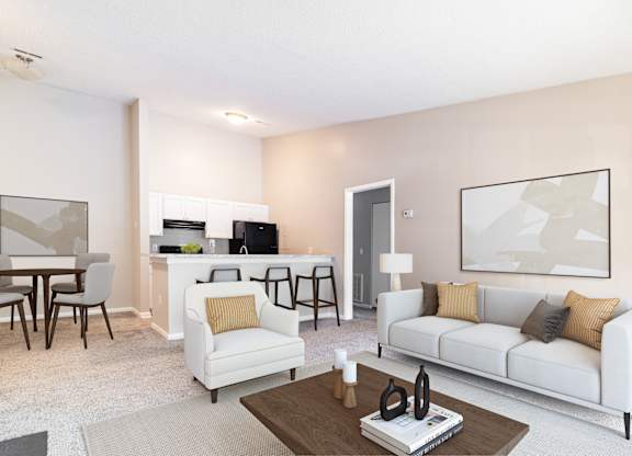 A modern living room with a white sofa, a coffee table, and a dining table.