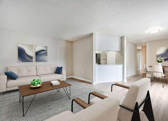 A living room with a couch, chair, and table.